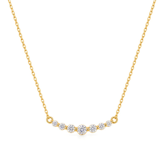 A delicate gold chain necklace featuring a curved bar pendant set with five small round-cut clear gemstones, displayed against a solid white background.
