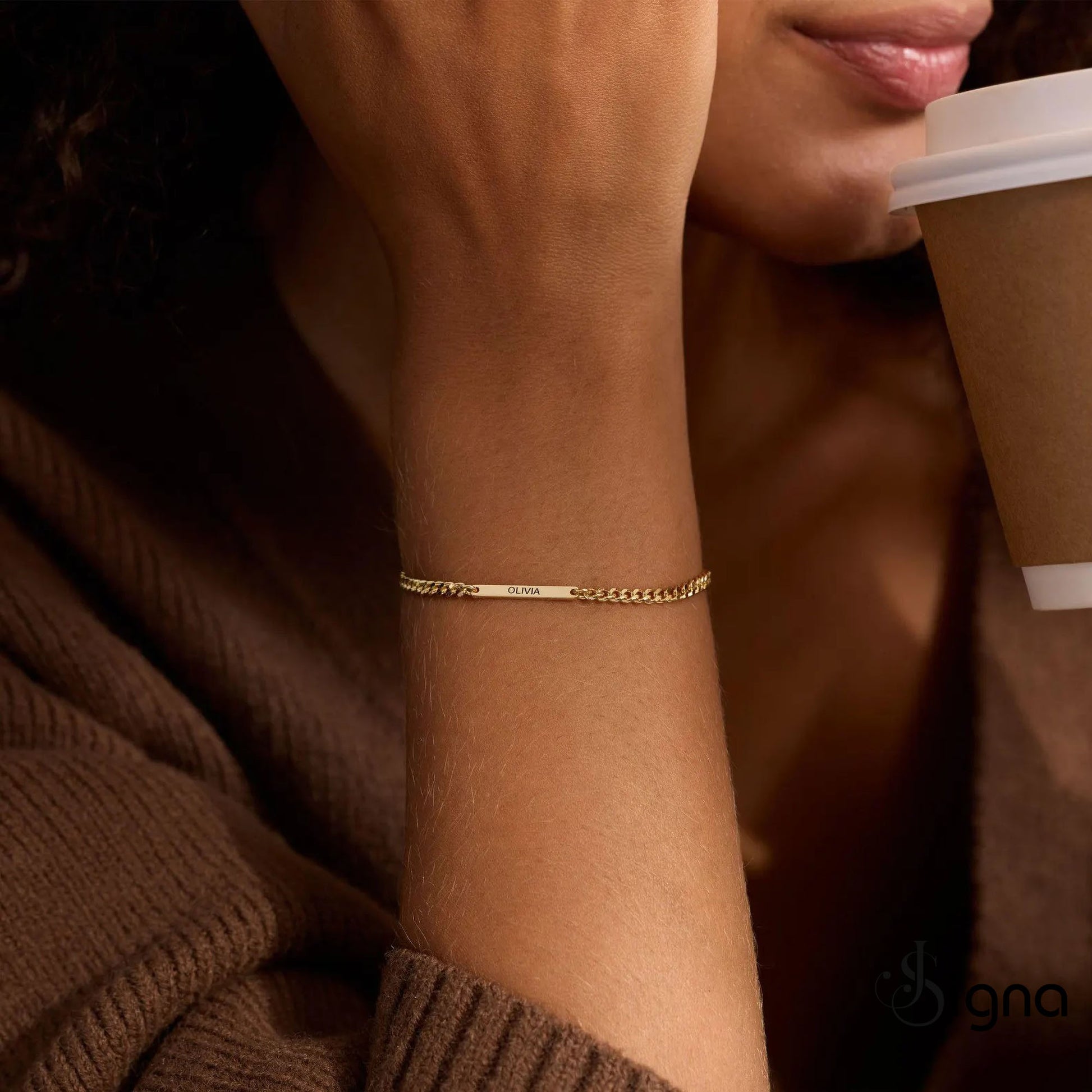 Personalized gold name bar bracelet with engraved Olivia on adjustable curb chain