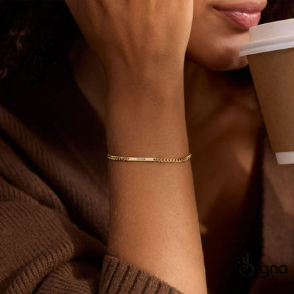 Personalized gold name bar bracelet with engraved Olivia on adjustable curb chain