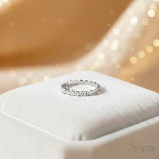 Close-up of engraved custom name scallop ring