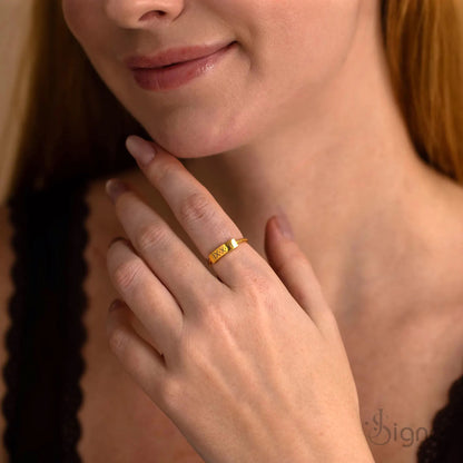 Minimal gold engraved name ring close up