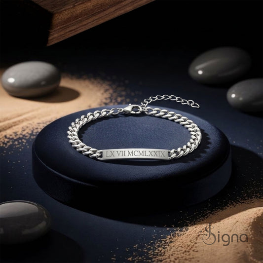 A man wearing the Signa™ Silver Engraved Bar Bracelet paired with a wristwatch for a stylish look.