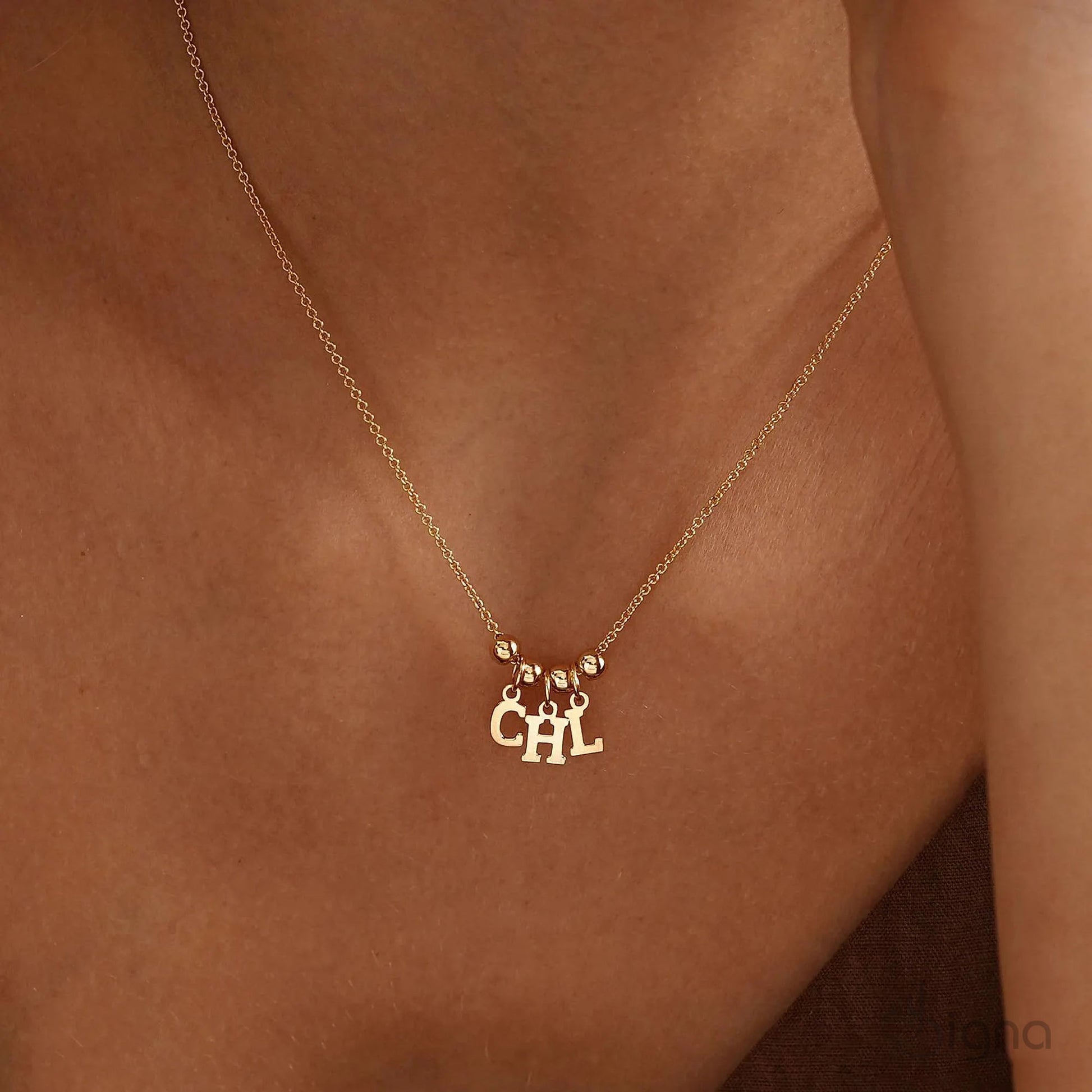 Handmade personalized name necklace with letter charms and bead accents