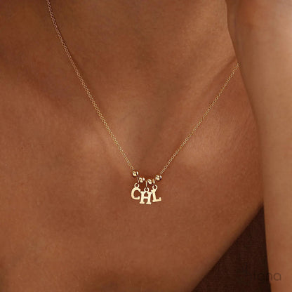 Handmade personalized name necklace with letter charms and bead accents