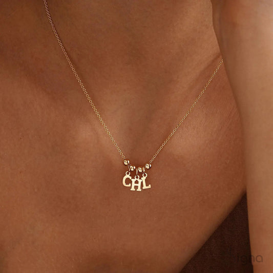 Handmade personalized name necklace with letter charms and bead accents